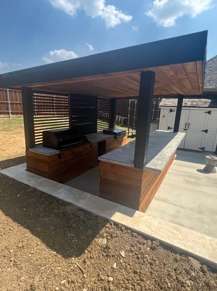 Custom freestanding pavilion with a full outdoor kitchen and bar seating